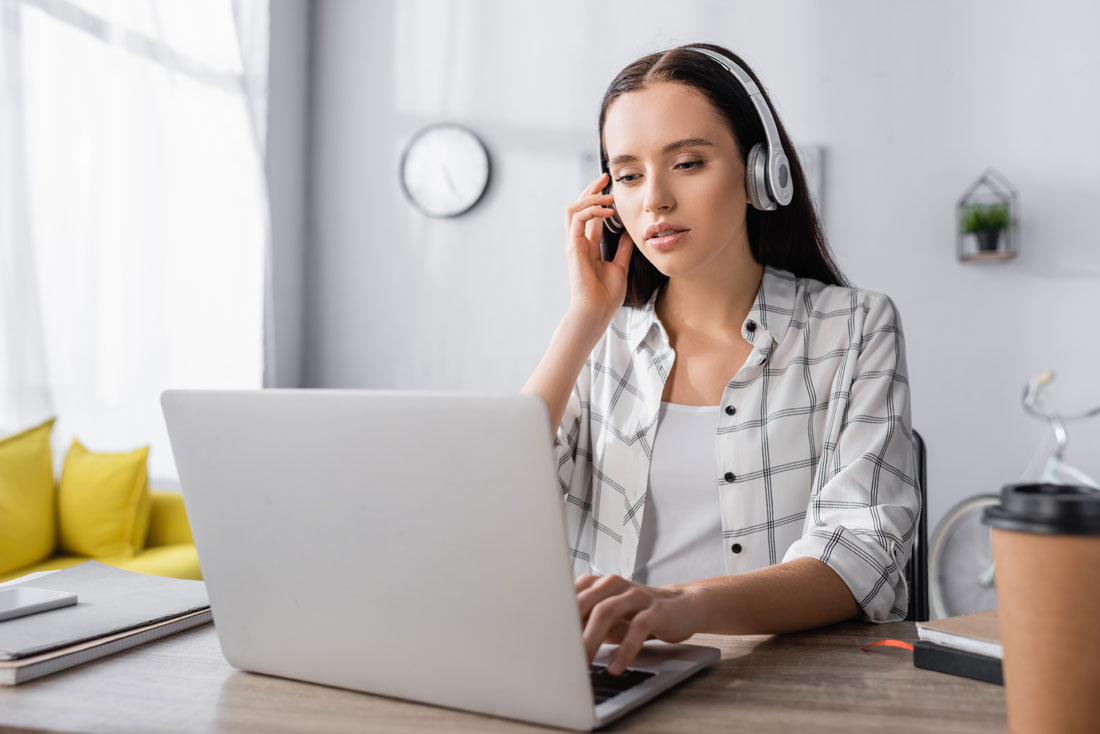 Transcriptionist listening intently during audio transcription.