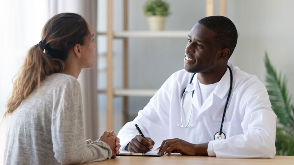 Doctor talking with patient rather than struggling with an EMR.