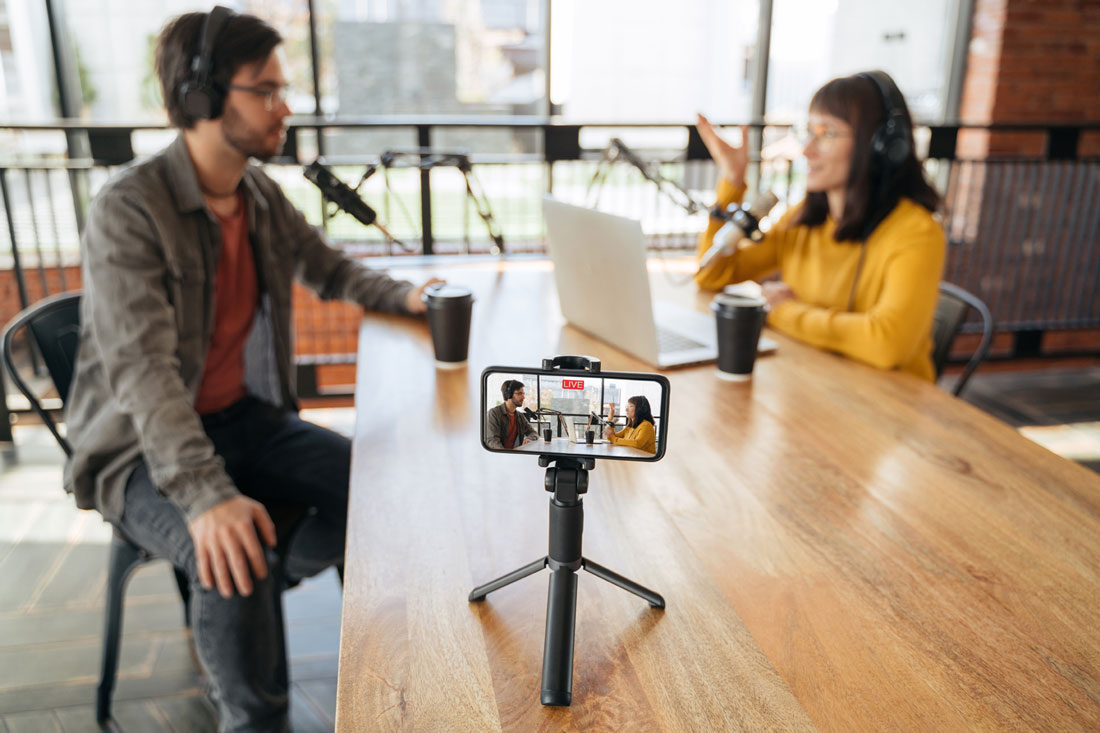 Two video podcasters. Video transcription provides a transcript of your content for better SEO.