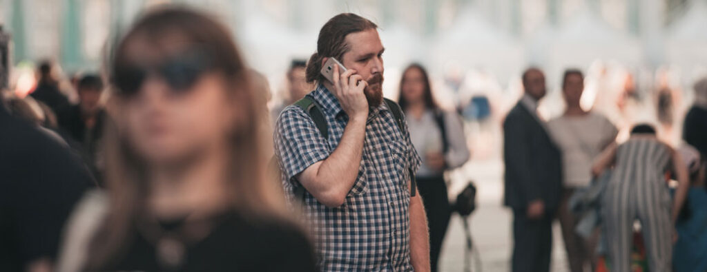 Nervous person calling on the phone and photographed by a private investigator recording notes for private investigation transcription | Private Investigator Transcription Services | Preferred Transcriptions